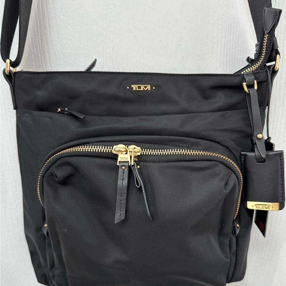 New TUMI Black and Gold Crossbody Bag